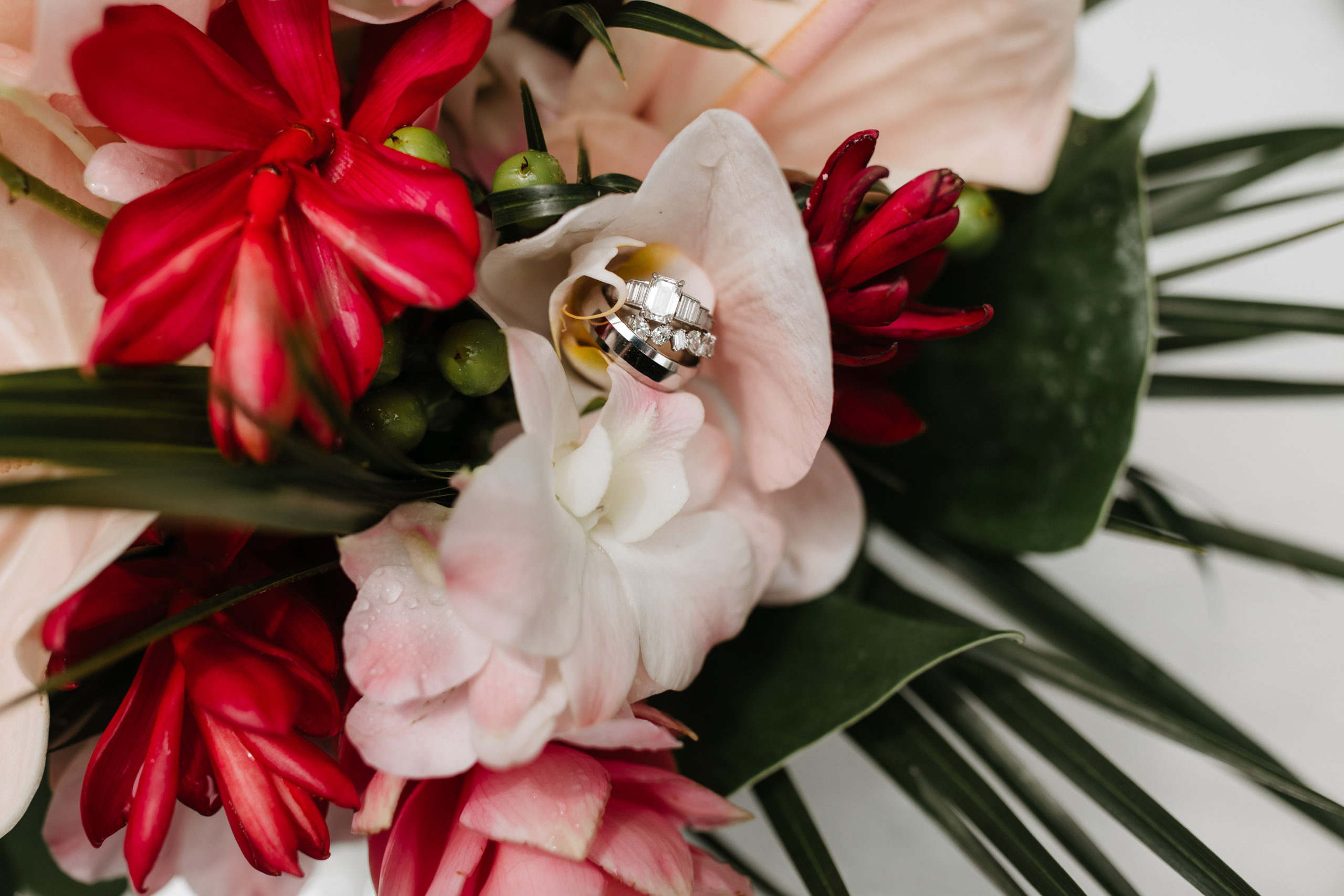 the details of the rings and the wedding flowers