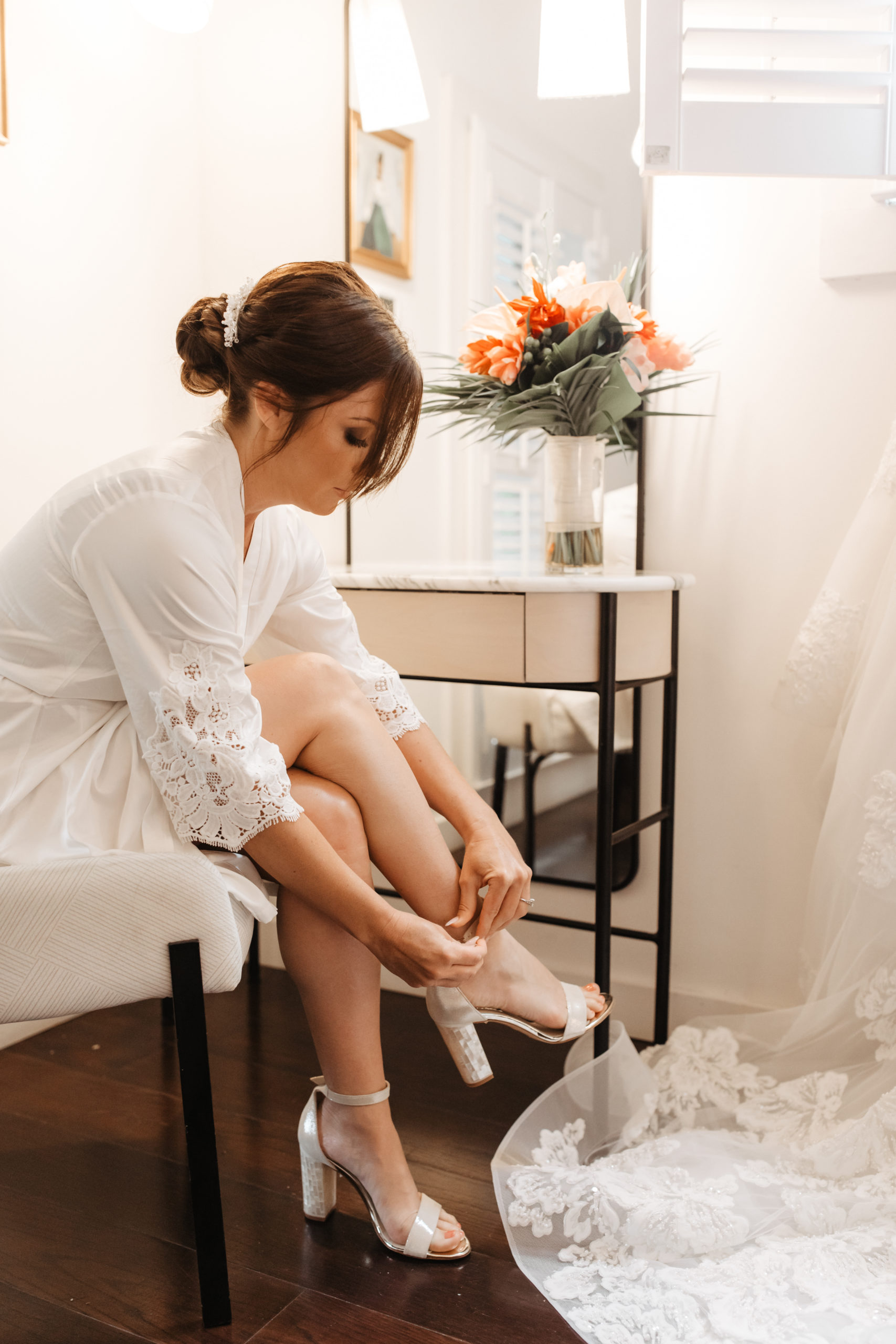 Bride lacing up her heels as she gets ready for her destination wedding