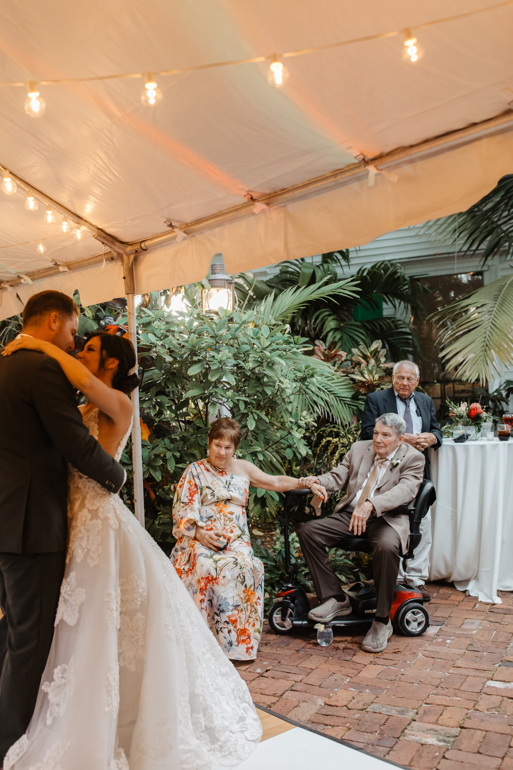 the mom and dad of the bride watch the first dance at the Florida wedding