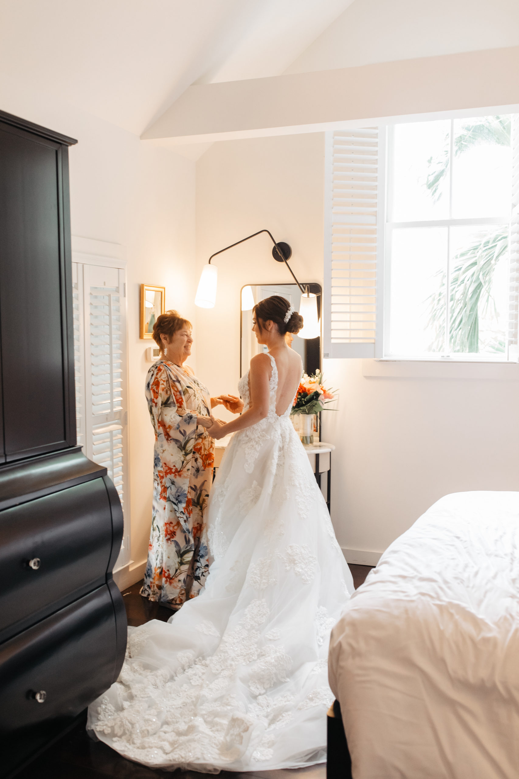 the bride and her mother stand together for the getting ready photos