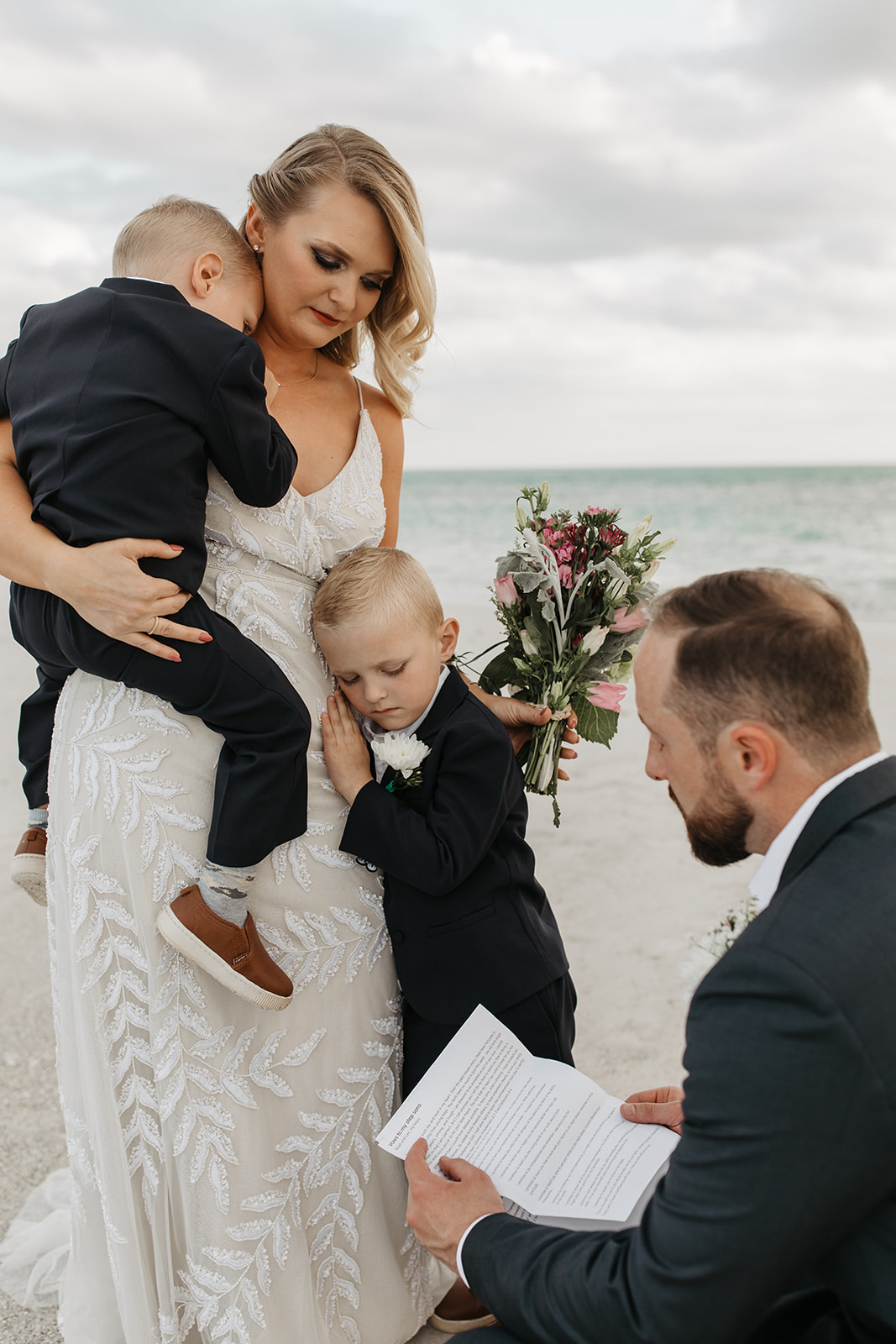 the bride holds her sons during her elopement ceremony