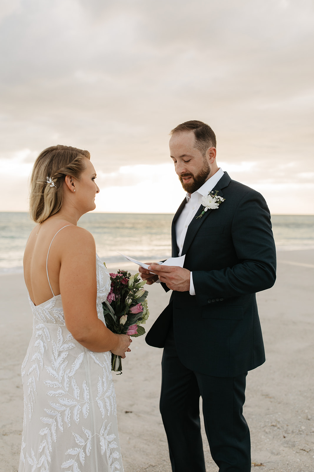 the groom reading his vows to his bride at Anna Maria Island in Florida