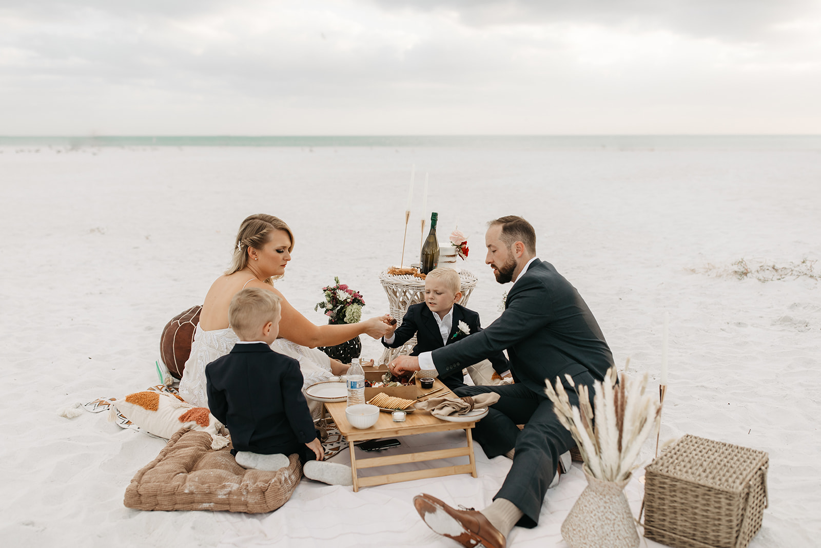 the family enjoying their picnic at the beach elopement