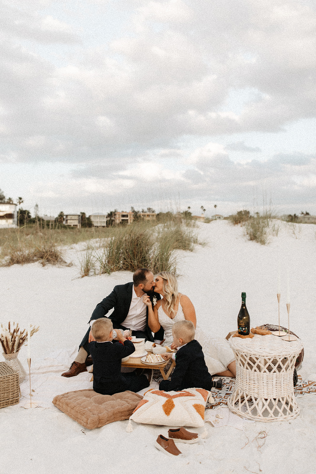 the bride and groom kissing at their beach elopement