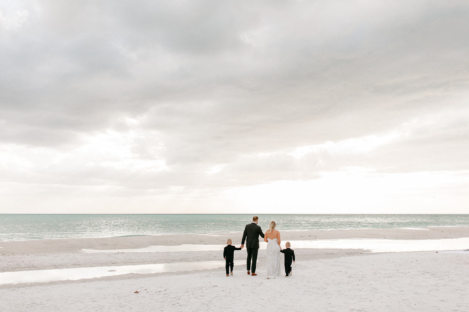 the family walking together across the sand at Anna Maria Island in Florida