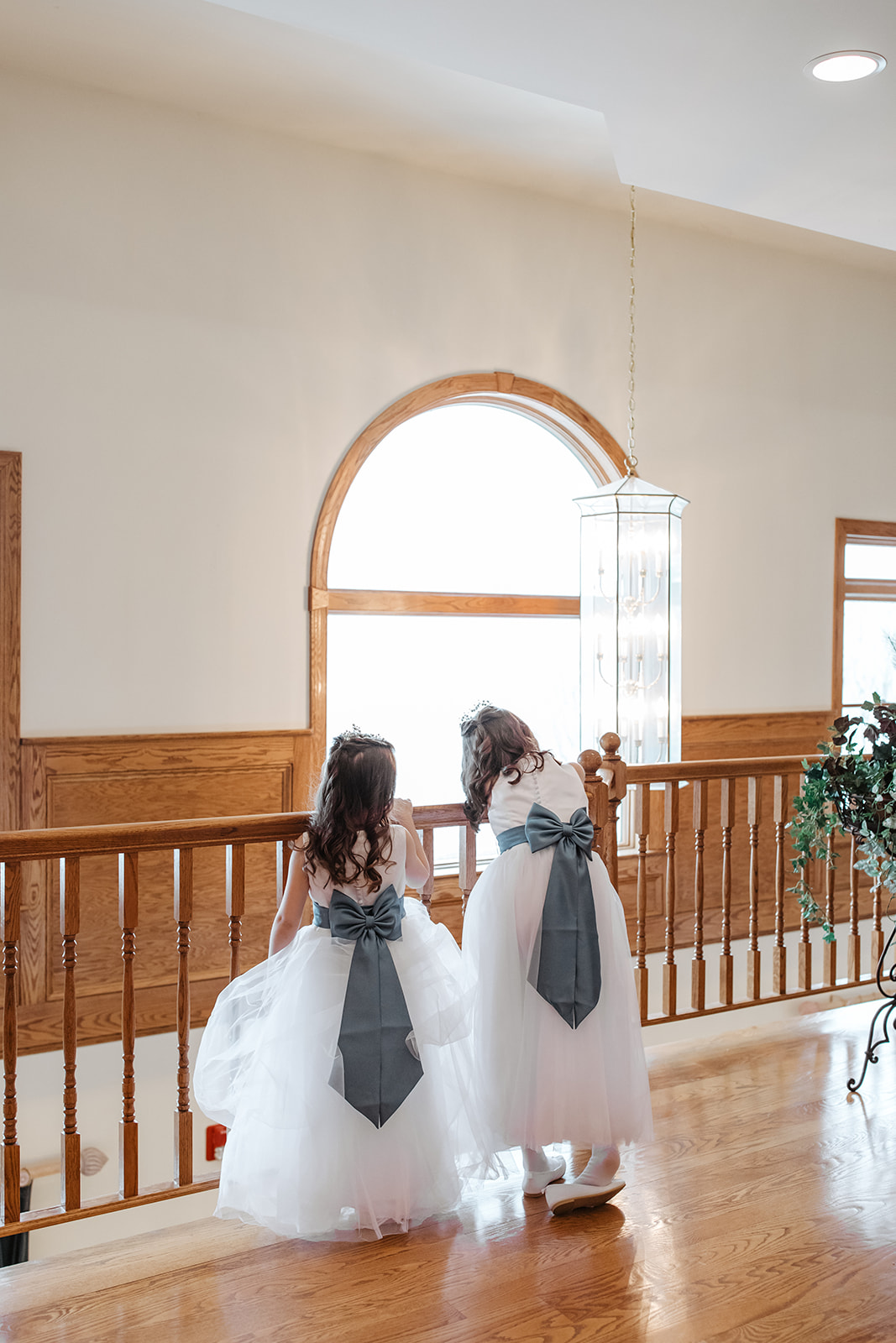 the flowergirls looking over the railing