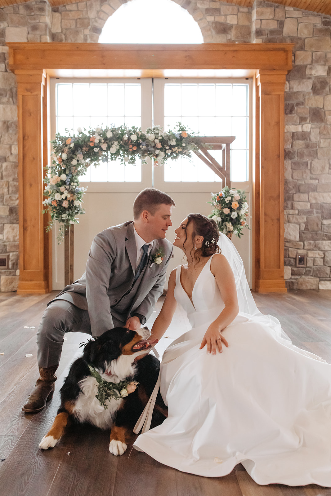 the bride and groom at the altar at Vignon Manor Farm with their dog