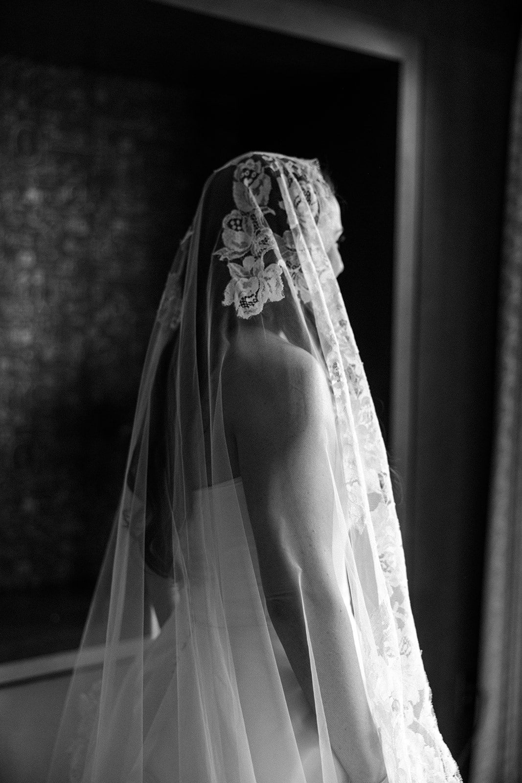 the lace veil over the bride's head