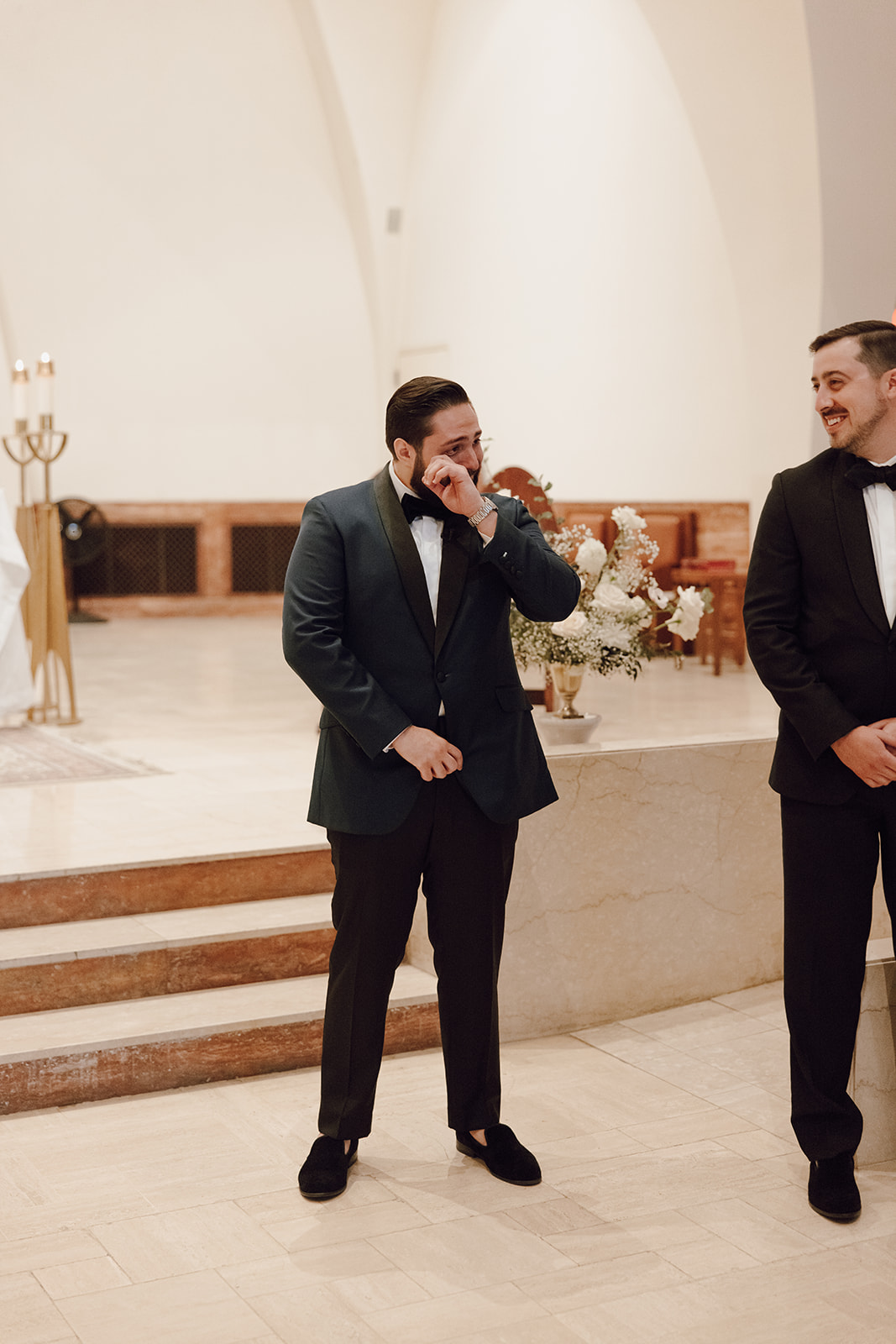 the groom brushing away his tears as the bride walks down the aisle