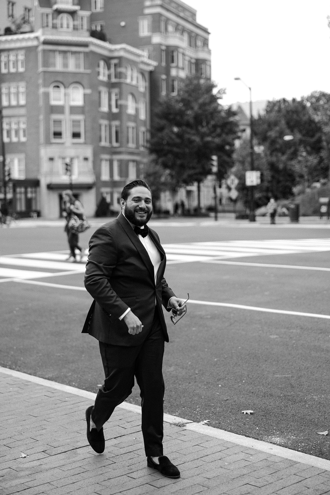 the groom walking down the street for the wedding ceremony