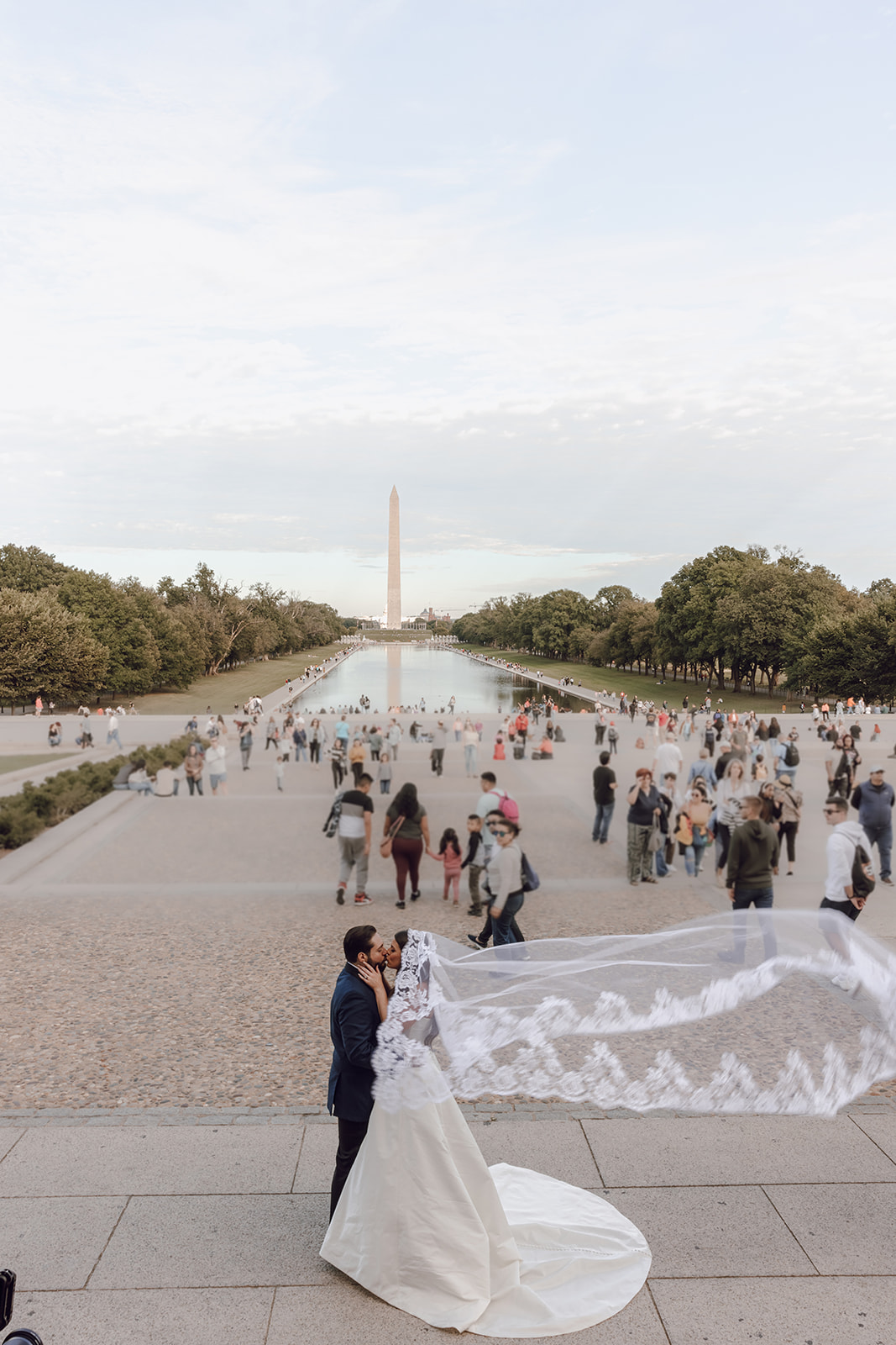 the couple standing near the Washington Monument captured by the wedding photographer in Washington DC