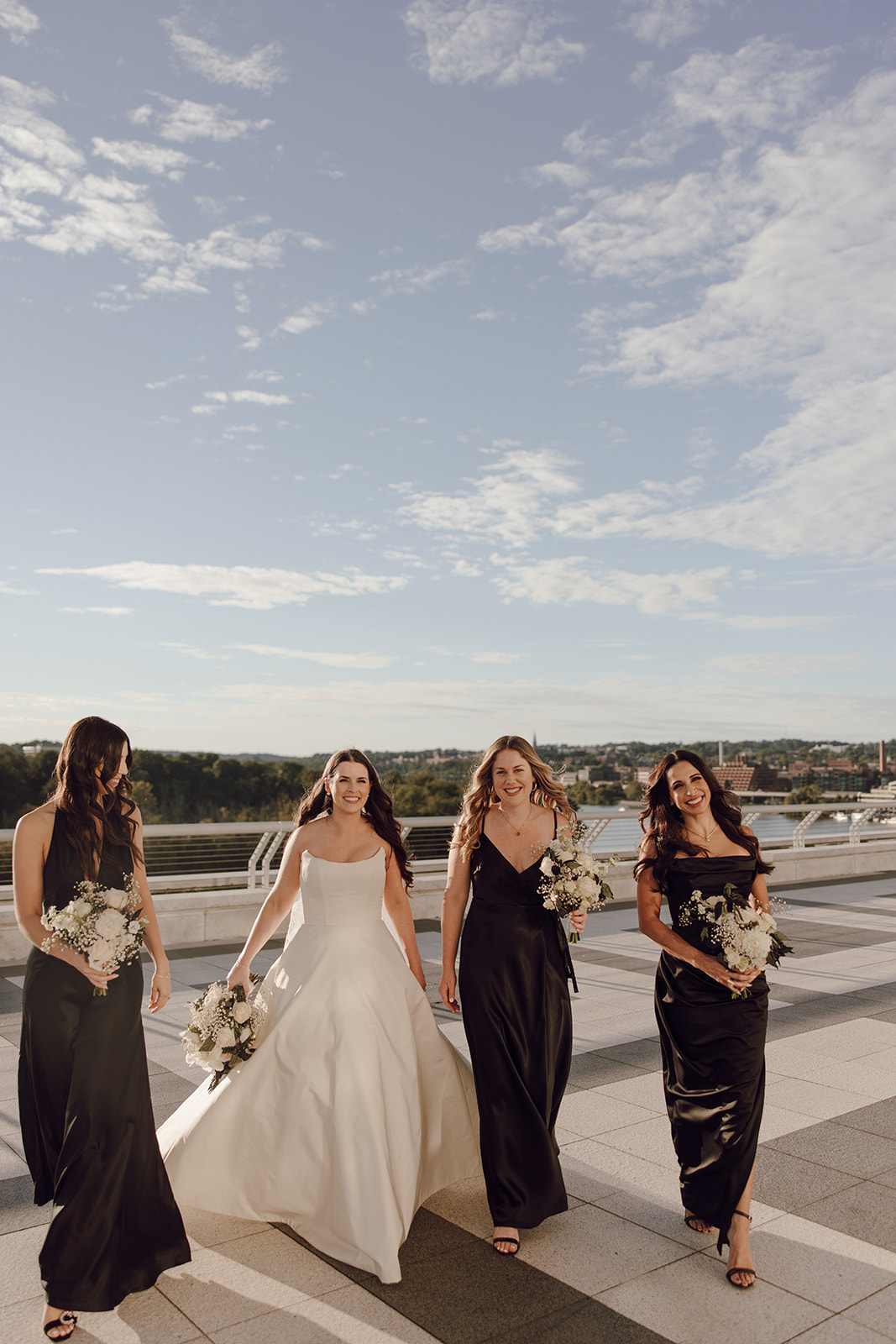 the bride walking with her bridesmaids captured by the wedding photographer in Washington DC