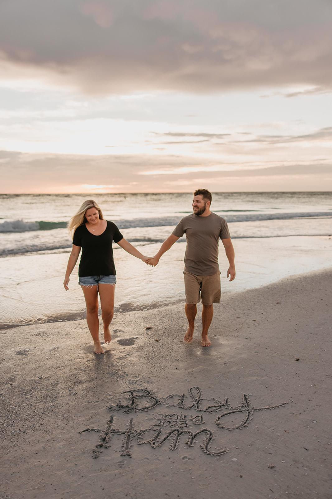 the couple holding hands as they walk towards the Florida couples photographer
