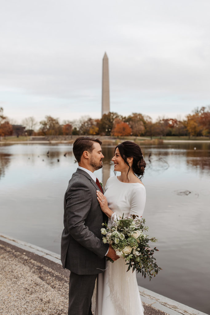 the couple smiling at one another during their wedding photos in Washington DC