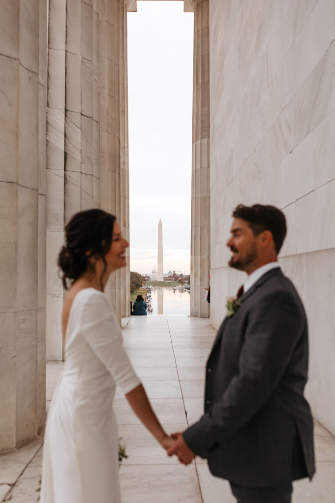 the wedding couple holding hands during their wedding photography in Washington DC