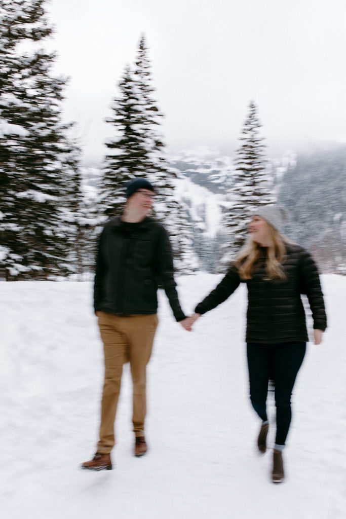 the couple walking together in the snow