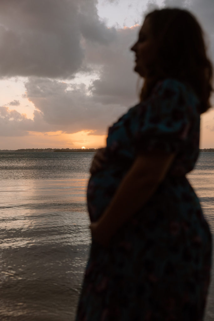 the mom with her bump during the sunset