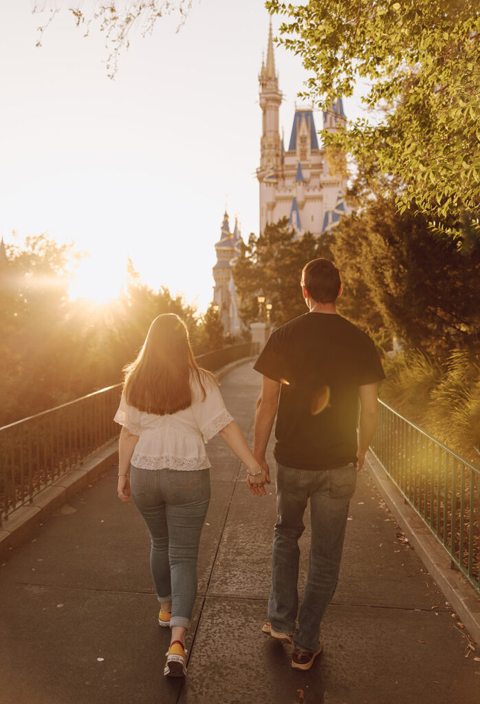 the couple walking out of the Magic Kingdom during their engagement session