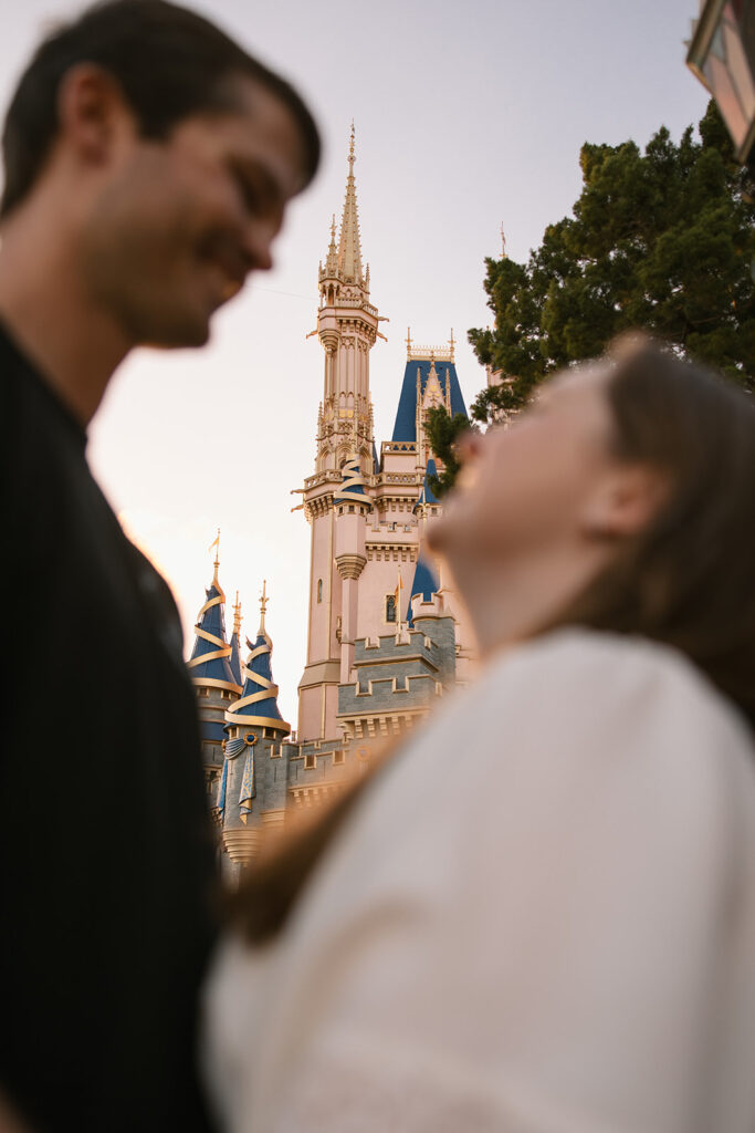 the Cinderella Castle in the Background for engagement photos Florida