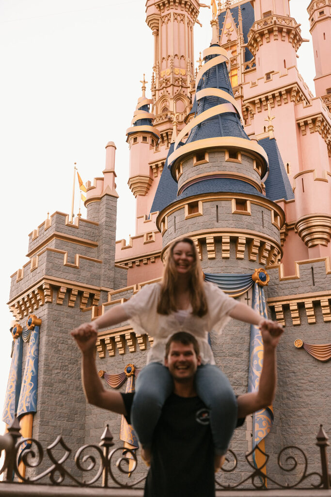 the fiance sitting on shoulders for fun couples photography poses for engagement photos Florida