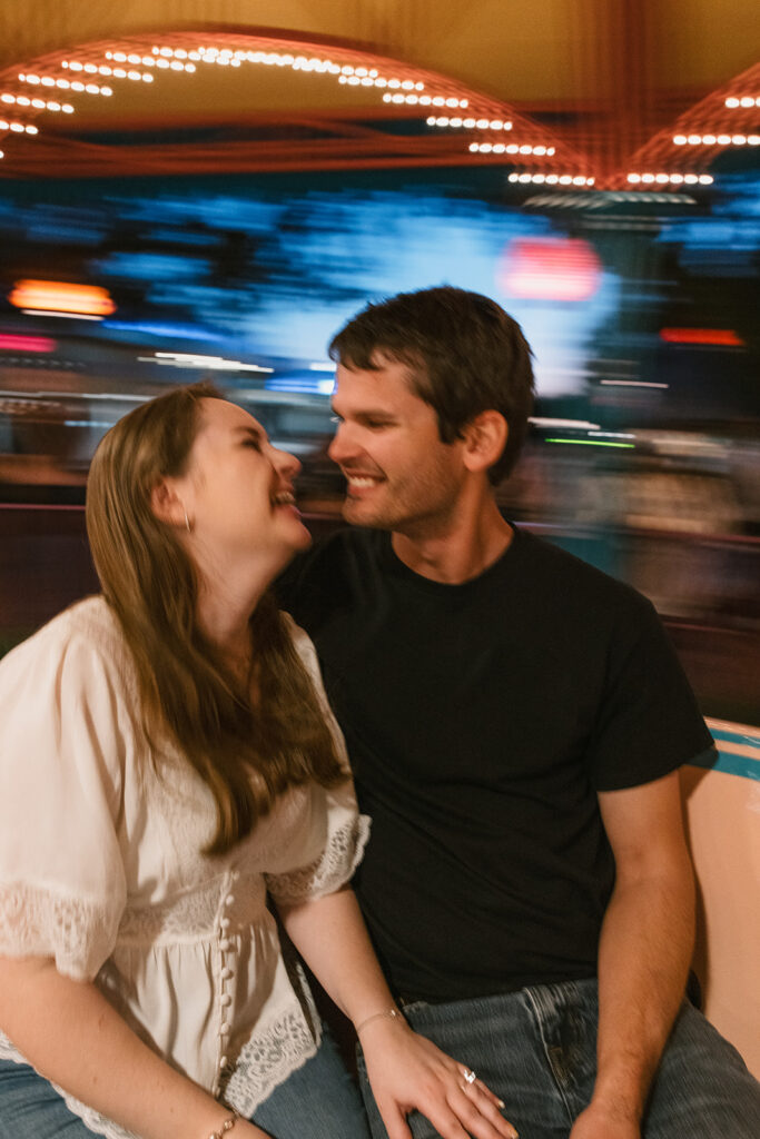 the couple laughing during their engagement photos Florida in Disney World