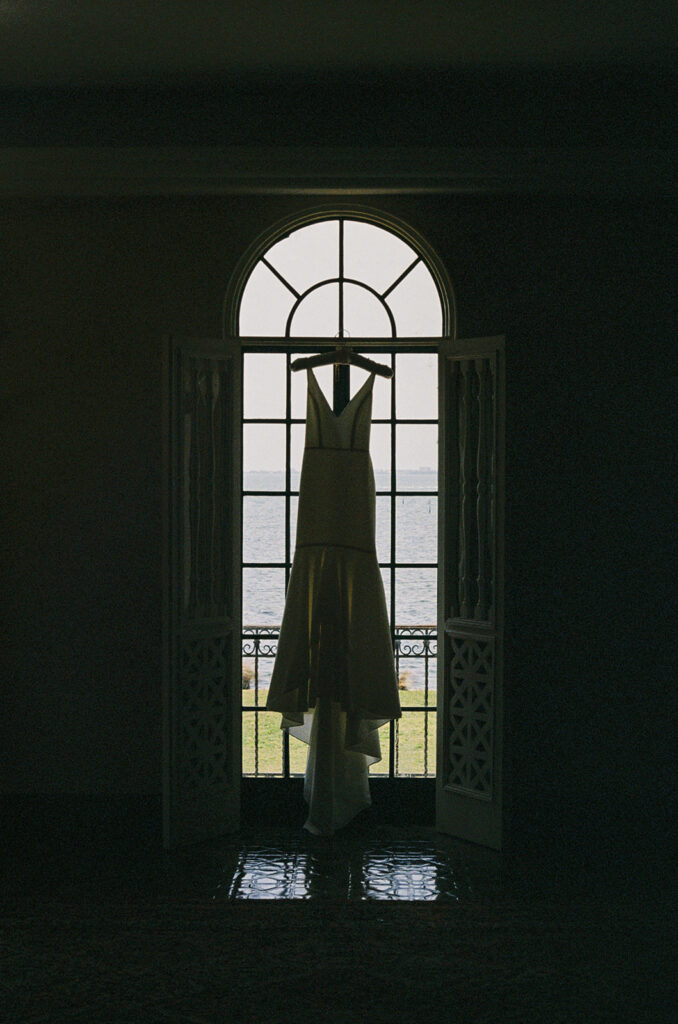 the wedding dress hanging in the window
