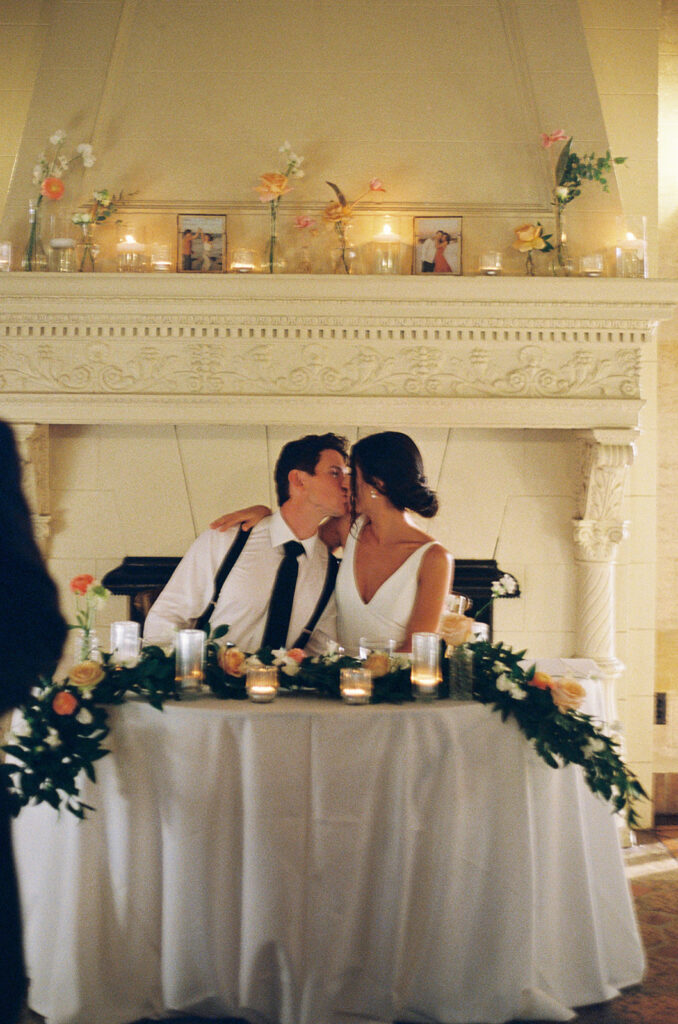 the bride and groom kissing at their wedding reception