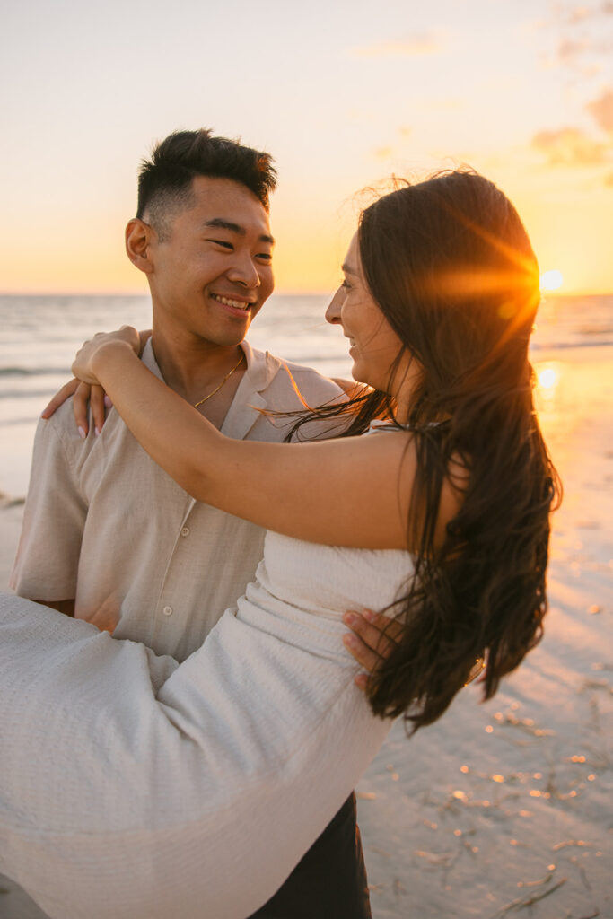Photoshoot Creative Ideas of Engaged Couple Playing Together on the Beach