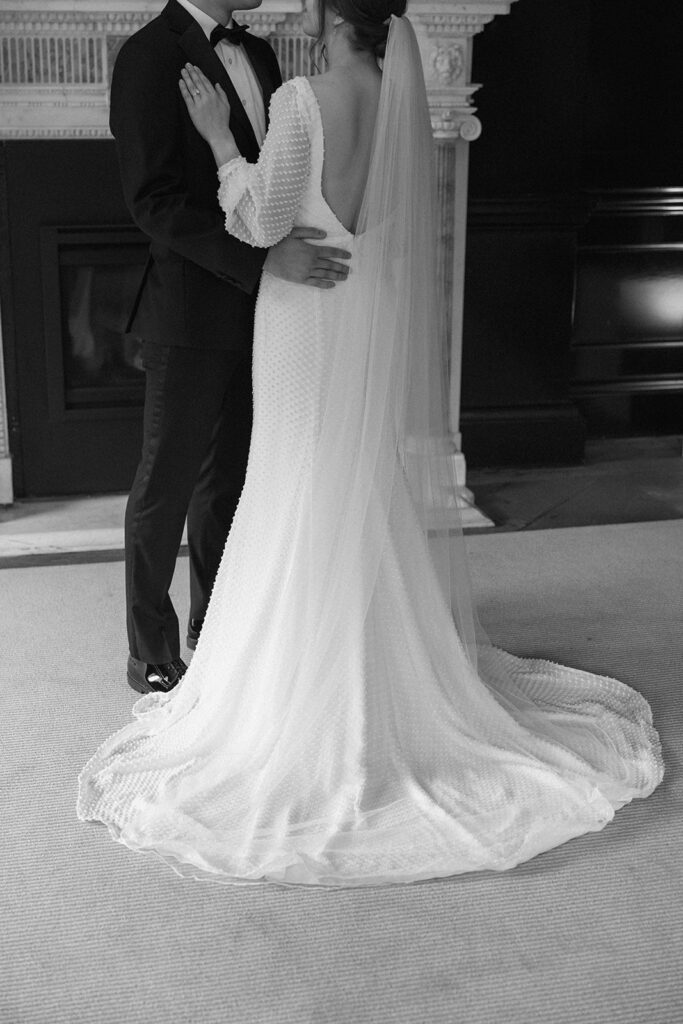 the bride and groom wedding portrait with wedding dress details