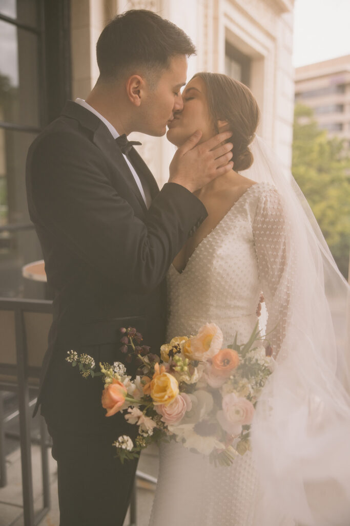 the bride and groom kissing at their wedding venue in washington dc