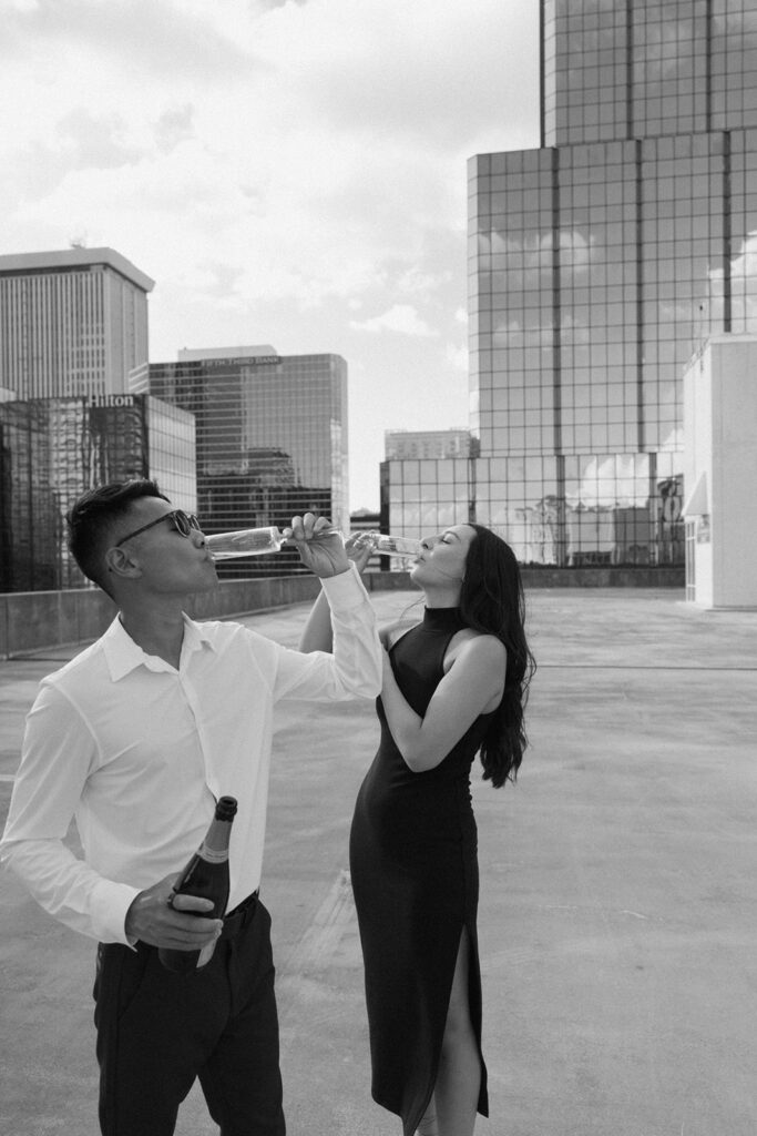 the engaged couple drinking champagne on a rooftop in Tampa