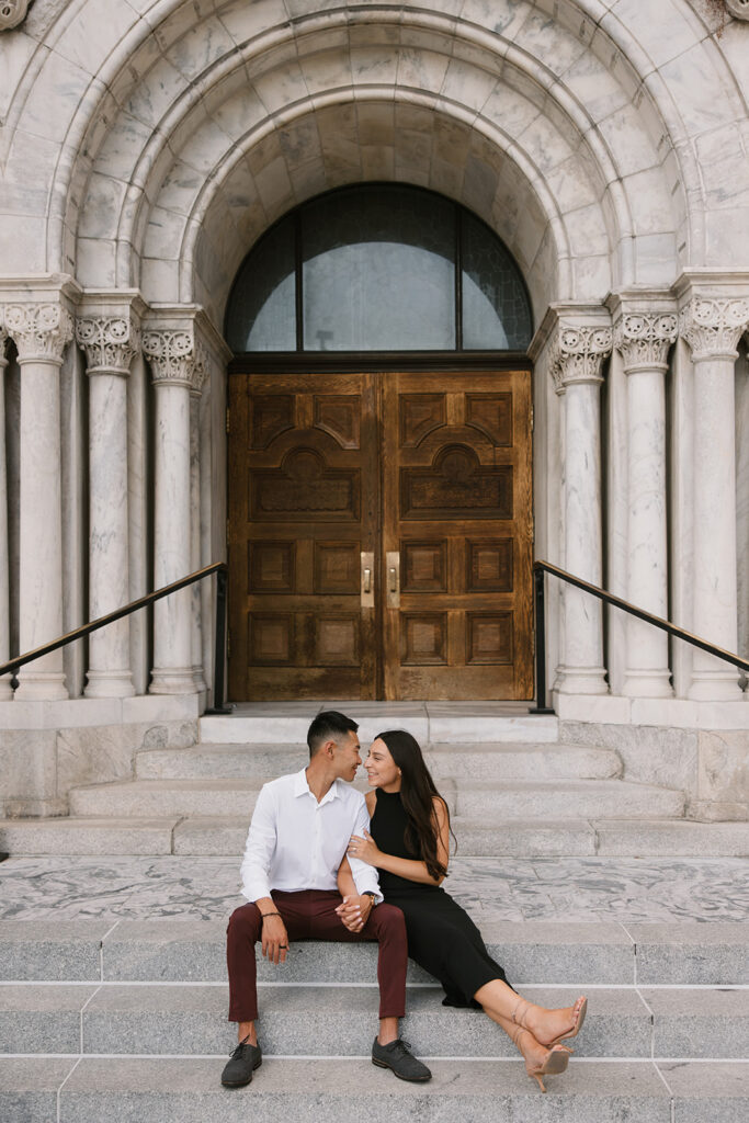 the engaged couple sitting on the stairs in downtown Tampa