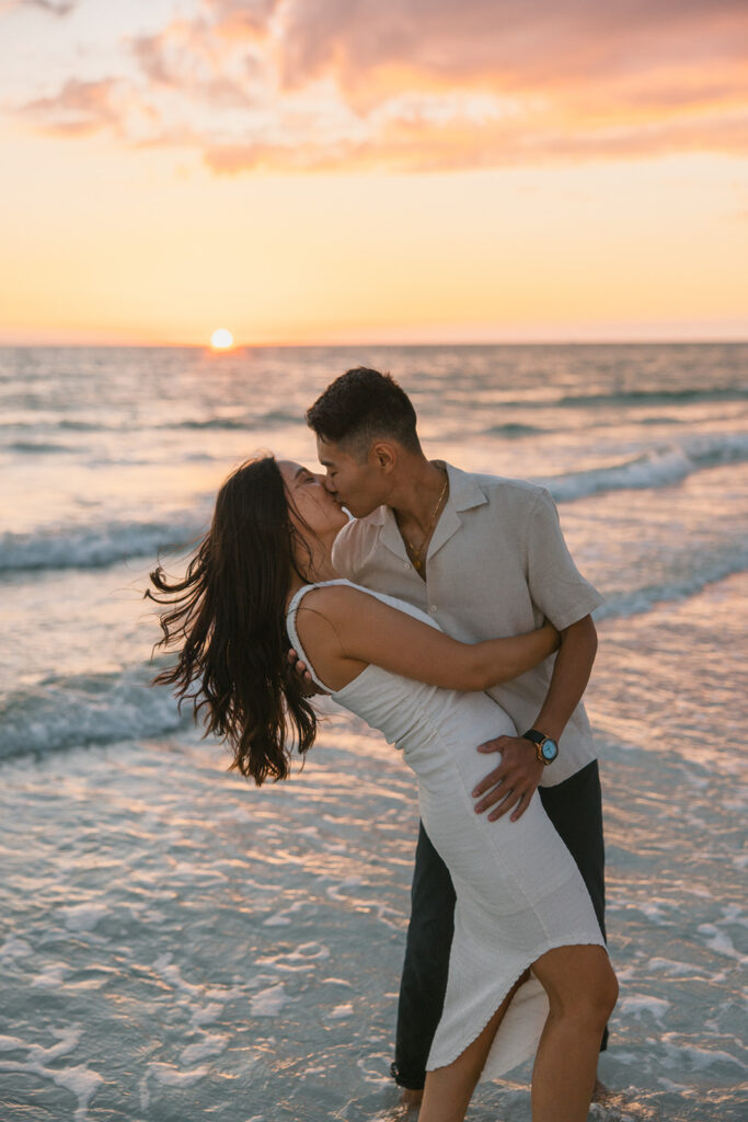 the engaged couple kissing in Tampa during their engagement photoshoot