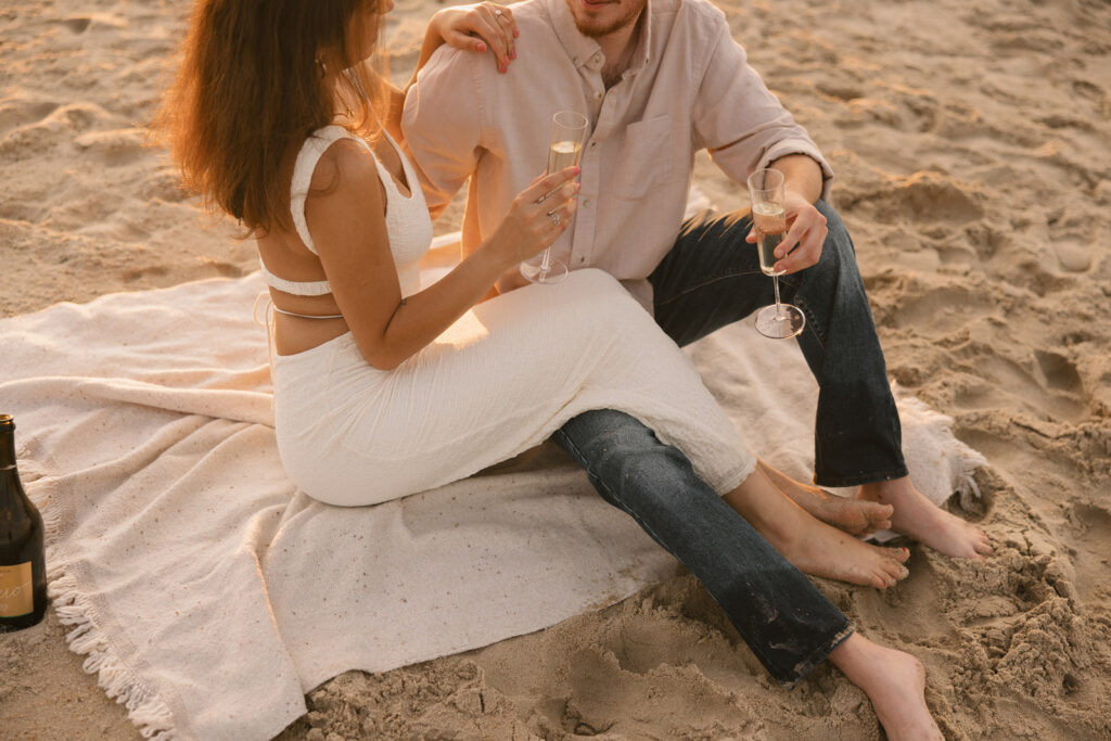 the couple enjoying their beach picnic for their beach engagement photos on the east coast