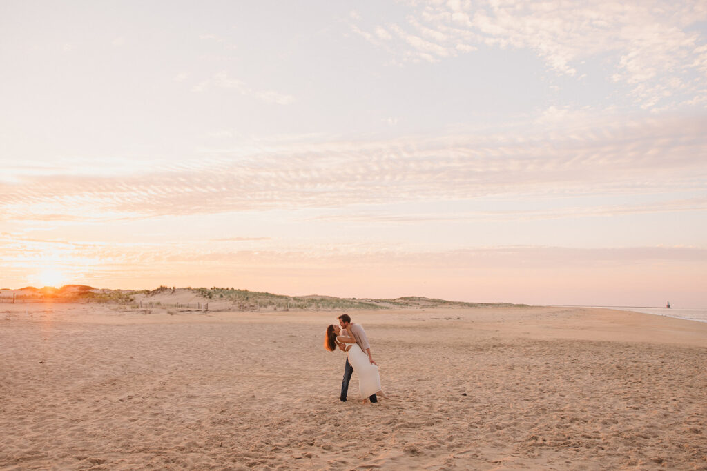 the engaged couple embracing during their sunset beach engagement photos
