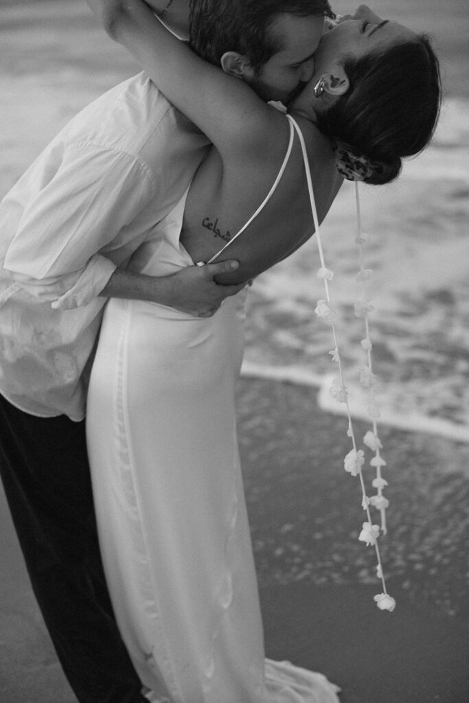 the engaged couple in a black and white photo on the east coast for beach engagement photos