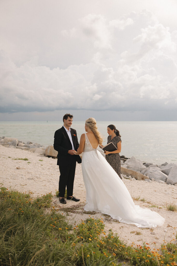 the bride and groom getting married on the beach during their Florida elopement