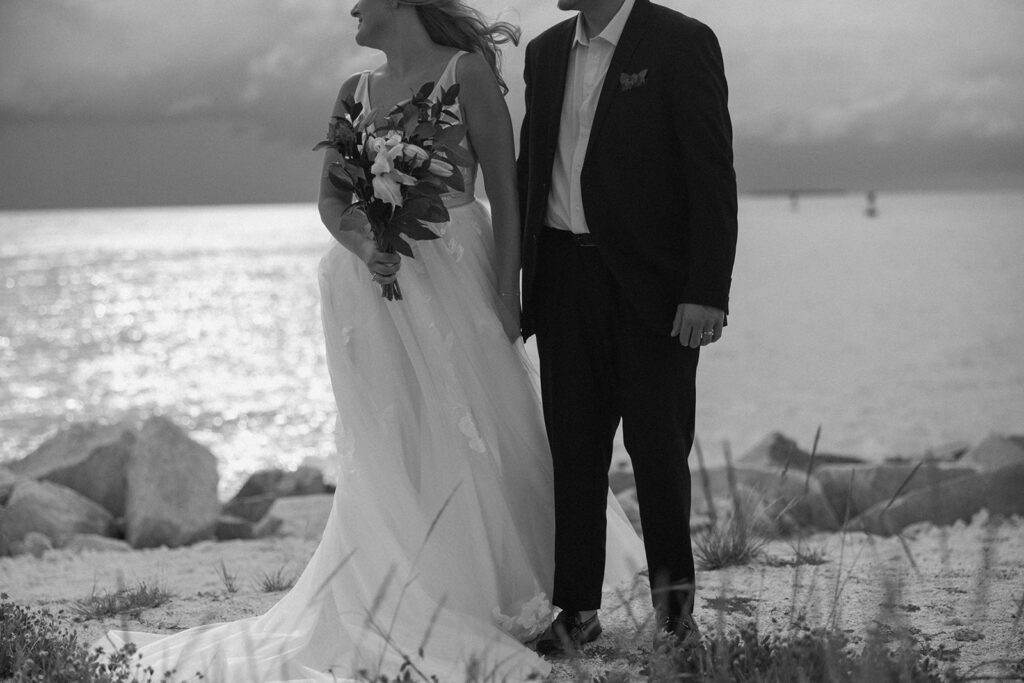 the bride and groom standing in a black and white elopement photo