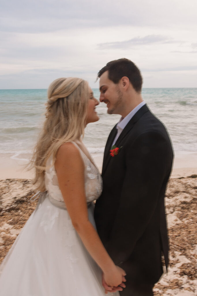 the bride and groom smiling at one another for their wedding photos in Key West