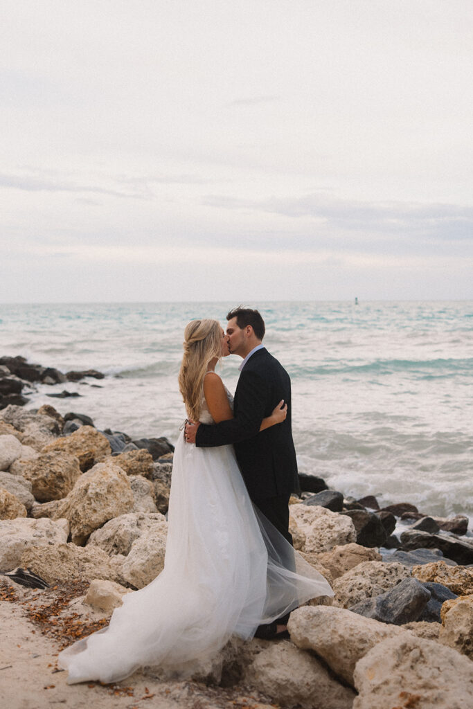 the bride and groom kissing on the shore during their Key West elopement