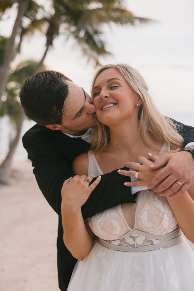 the groom hugging the bride on the beach during their Key West elopement