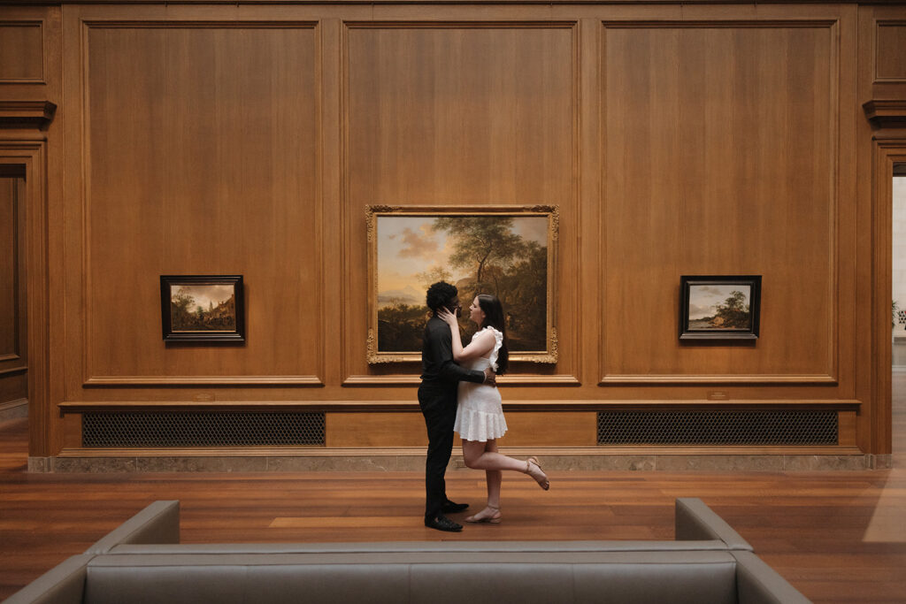 the engaged couple kissing at the National Gallery of Art