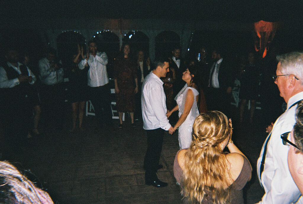 the bride and groom dancing together at their wedding reception
